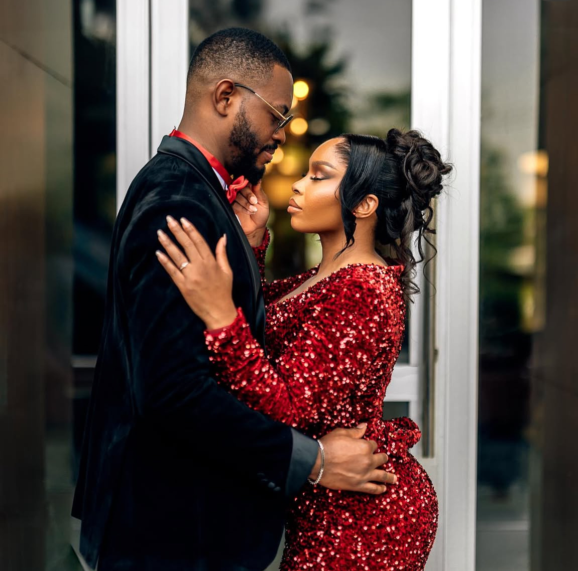 Couple embrace with engagement ring